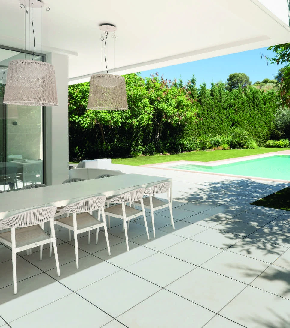 Covered dining terrace beside a private garden in El Paraiso