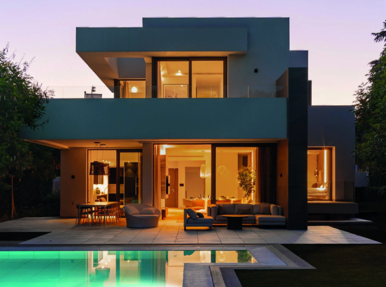 Illuminated villa and private pool at dusk in El Paraiso