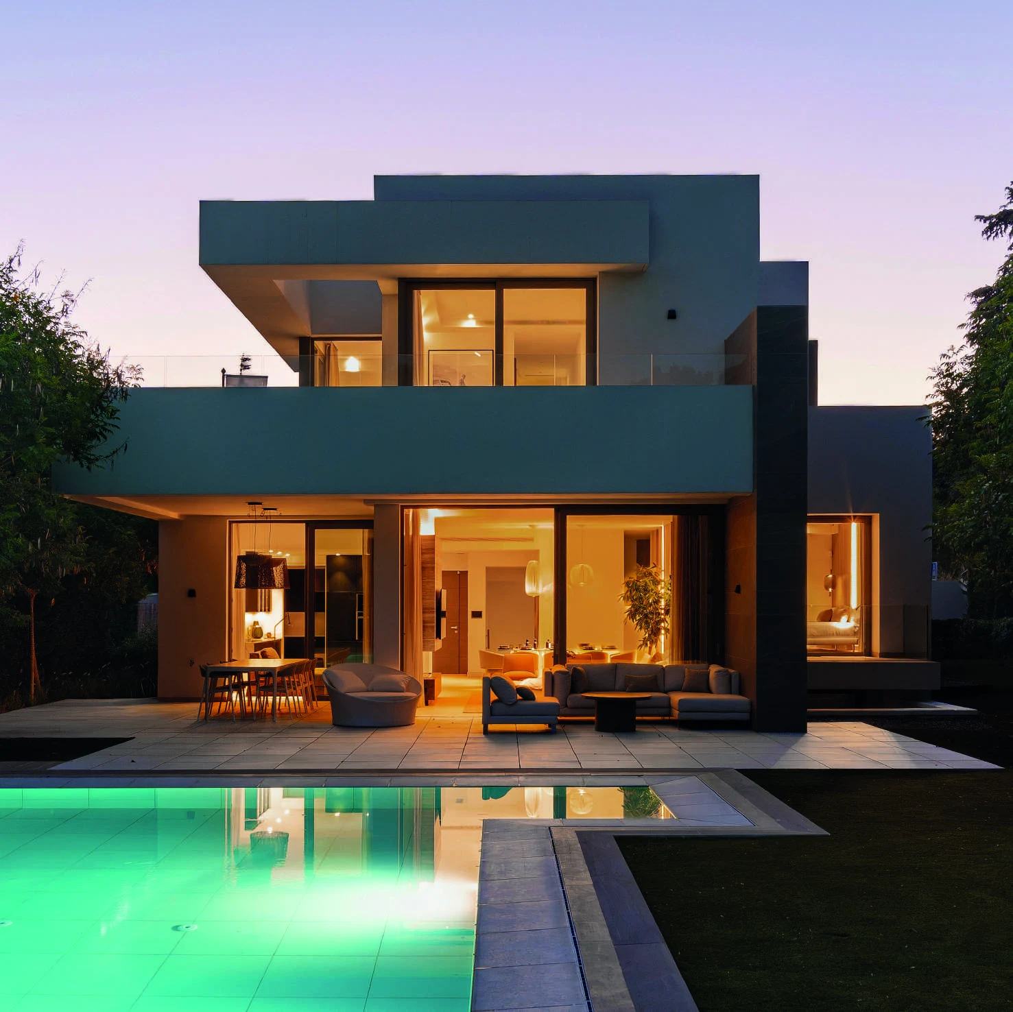 Illuminated villa and private pool at dusk in El Paraiso