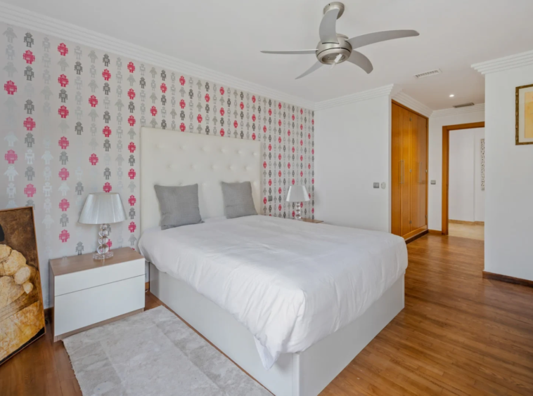 Additional bedroom with patterned wallpaper