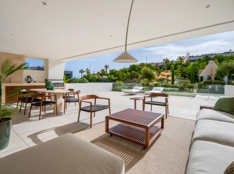 Covered terrace with outdoor dining and views of the communal gardens