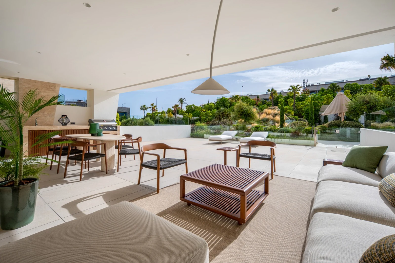 Covered terrace with outdoor dining and views of the communal gardens