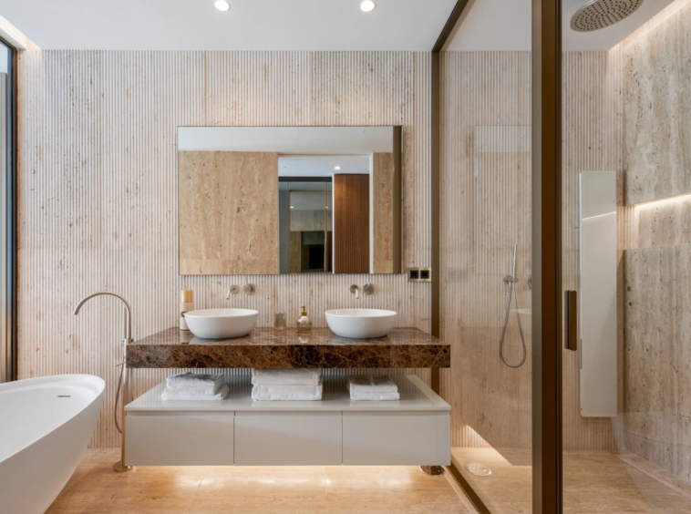 Double vanity and stone finishes in the main bathroom