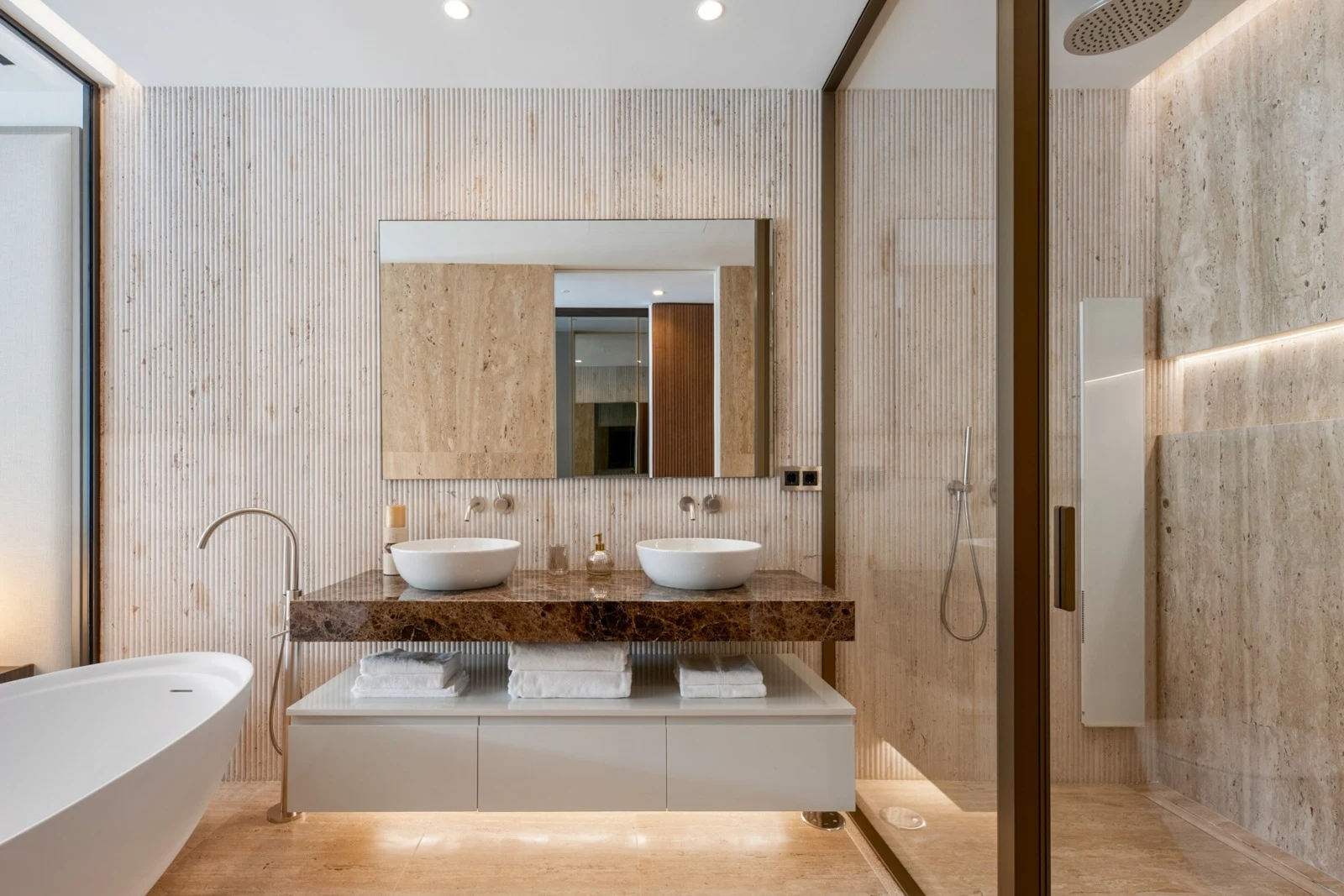 Double vanity and stone finishes in the main bathroom