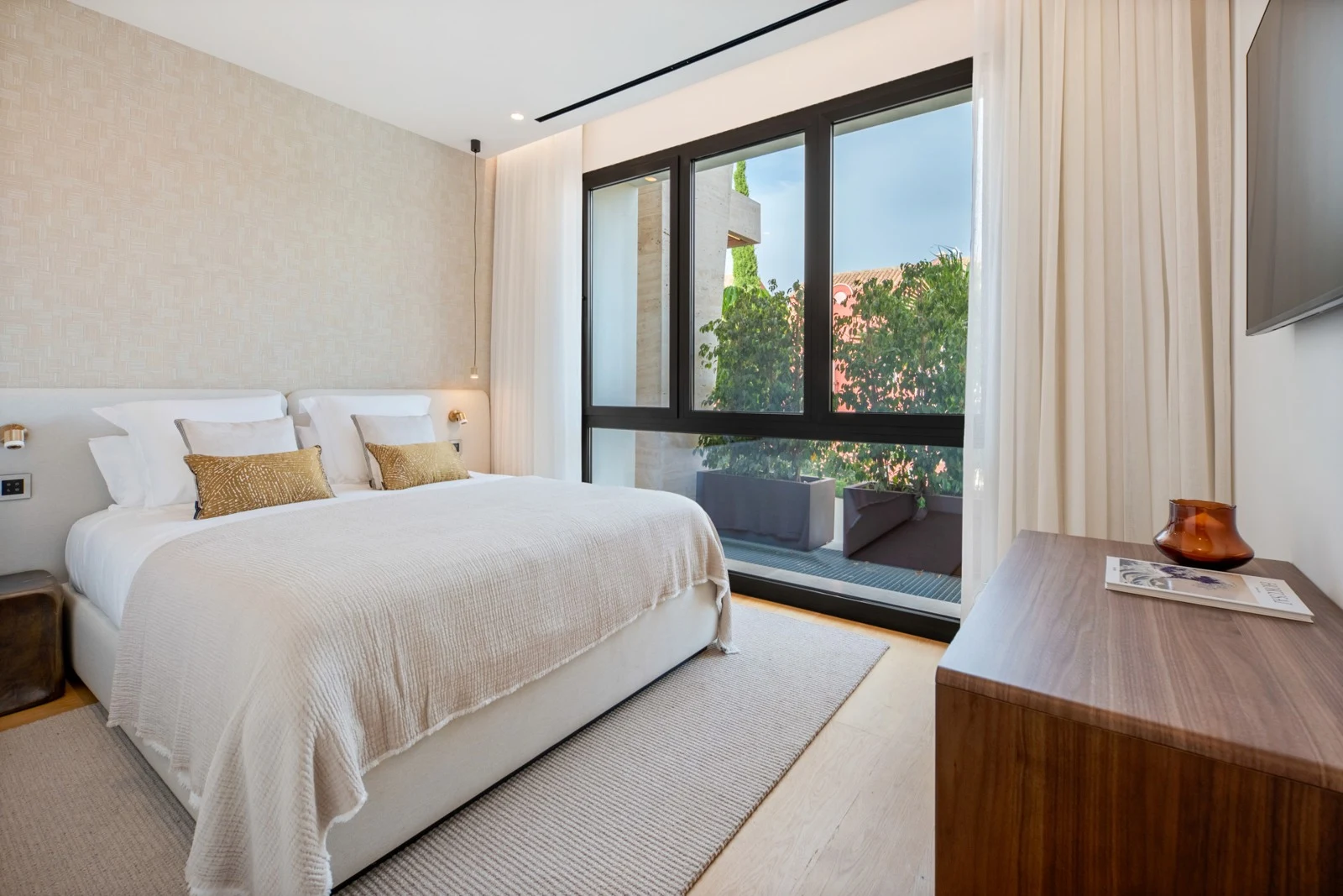 Bedroom with full-height windows and fitted storage