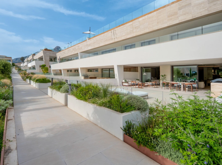 Ground-floor terraces beside the landscaped communal grounds