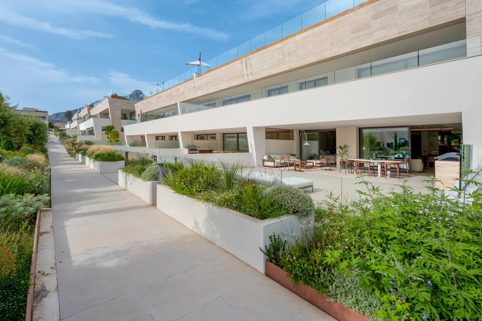 Ground-floor terraces beside the landscaped communal grounds
