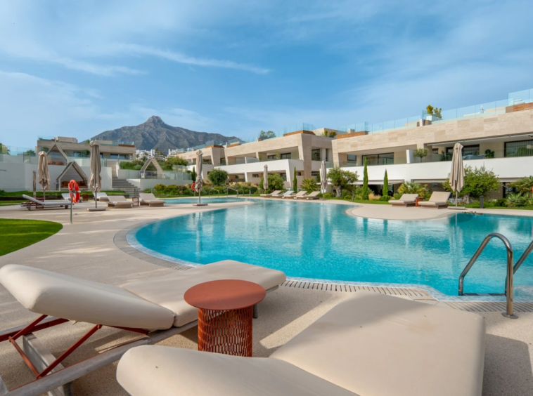 Communal outdoor swimming pool and landscaped gardens