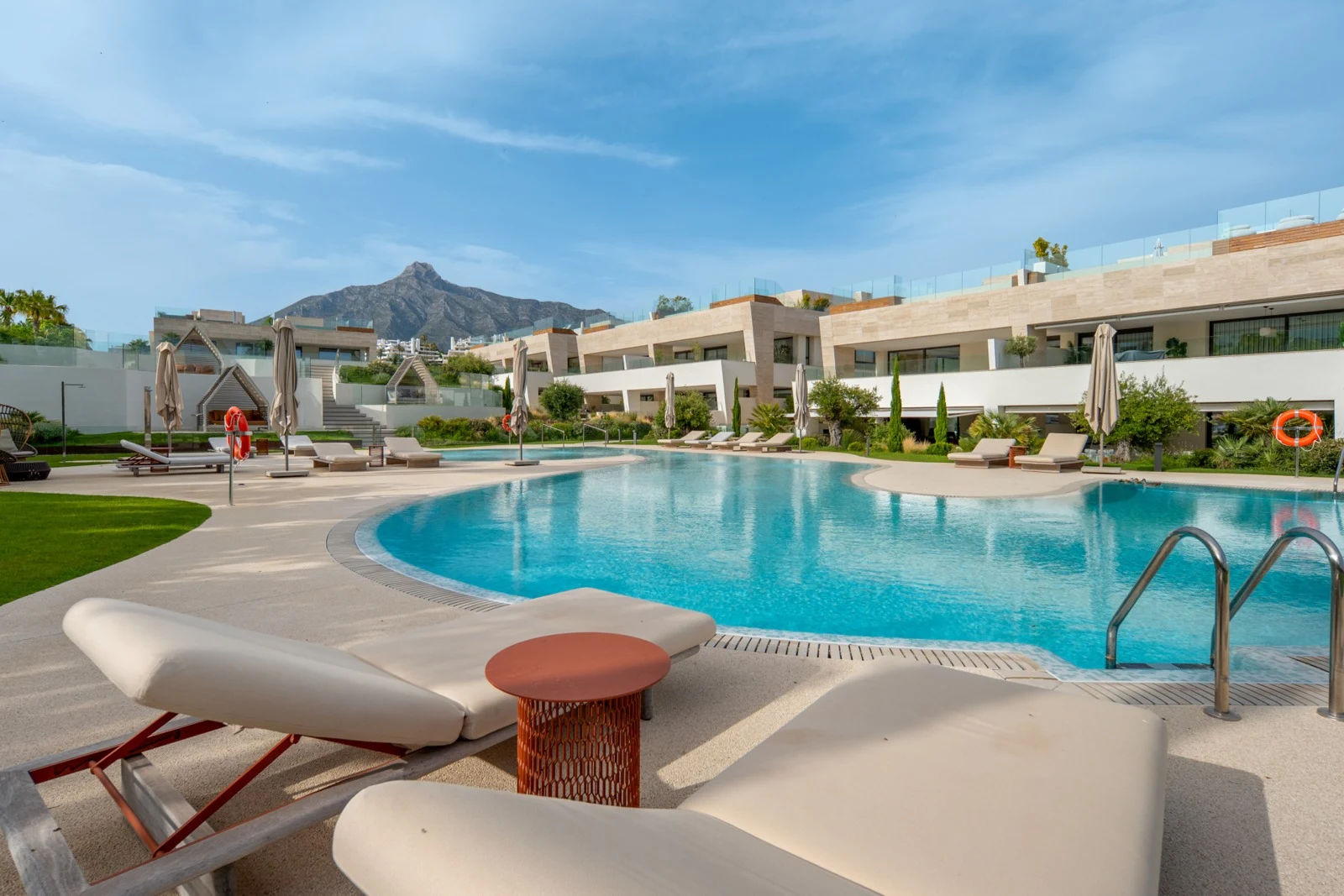 Communal outdoor swimming pool and landscaped gardens