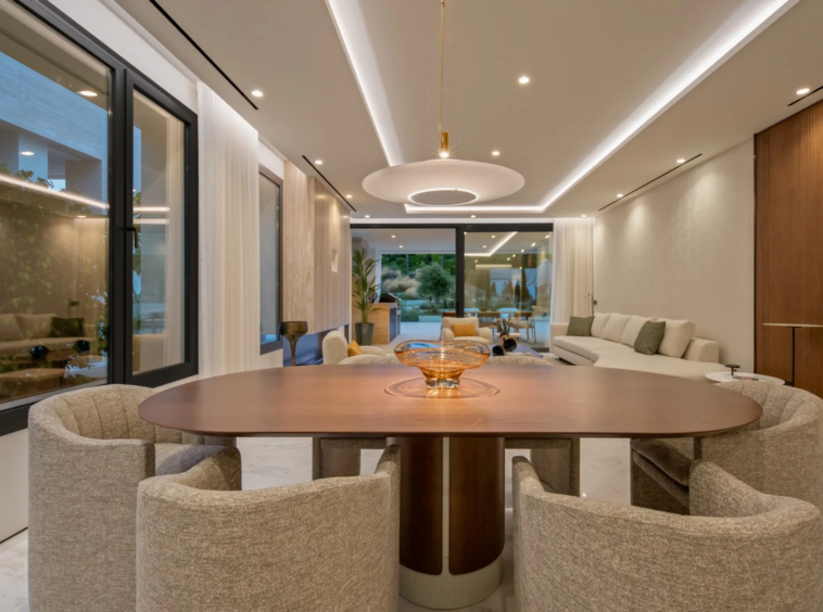 Dining area and living room illuminated at dusk