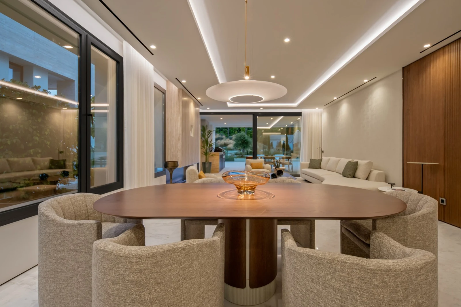 Dining area and living room illuminated at dusk