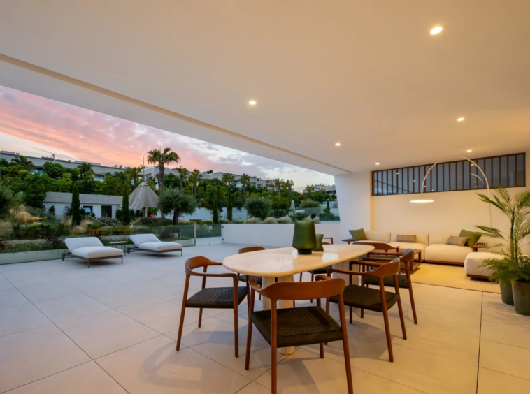 Outdoor dining terrace overlooking the communal gardens at dusk
