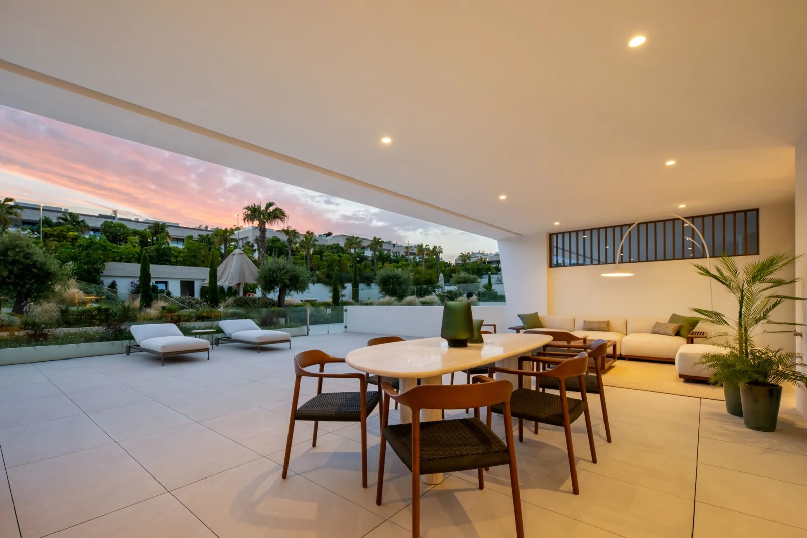 Outdoor dining terrace overlooking the communal gardens at dusk