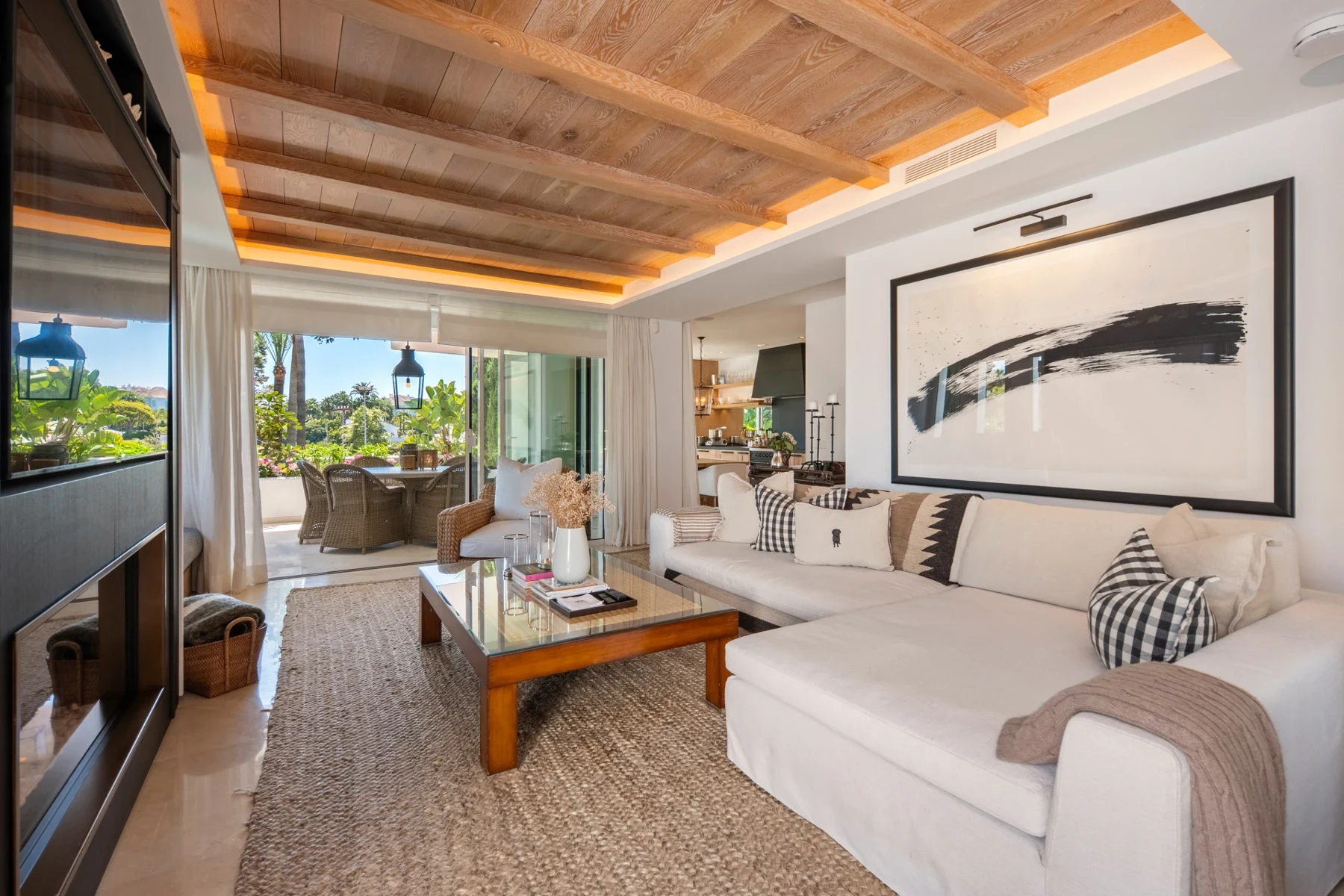 Living room with wood ceiling and terrace doors on Marbella’s Golden Mile