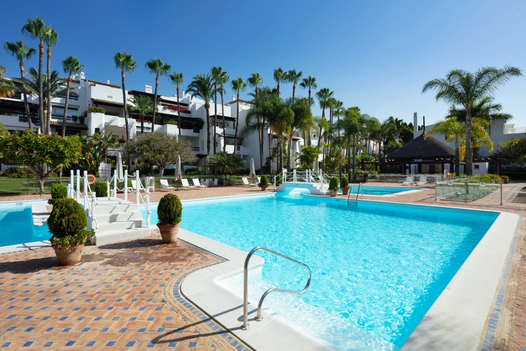 Communal swimming pool and landscaped grounds on Marbella’s Golden Mile