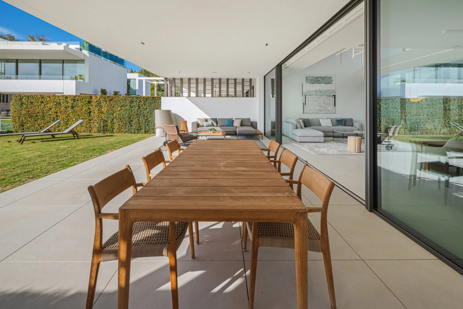 Covered outdoor dining terrace facing the garden