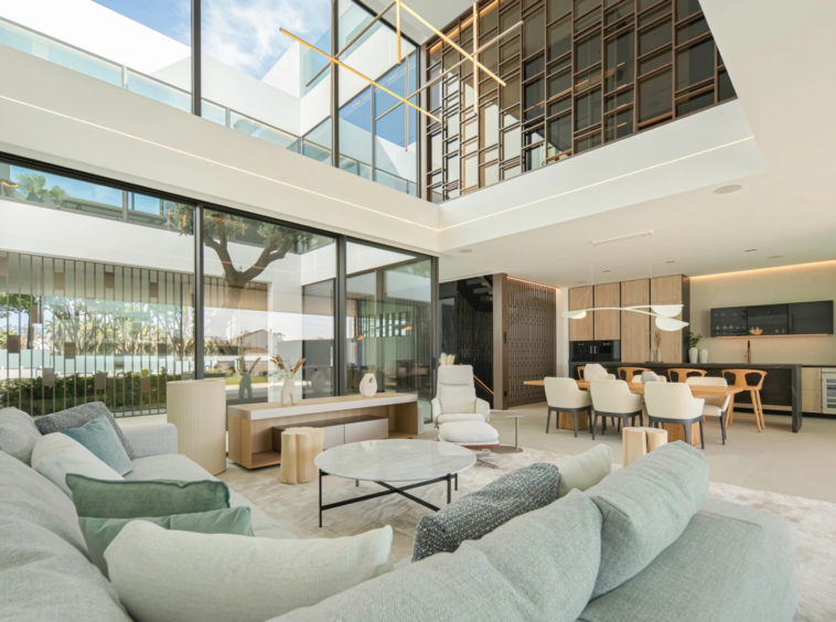 Double-height living room with broad sliding glass doors