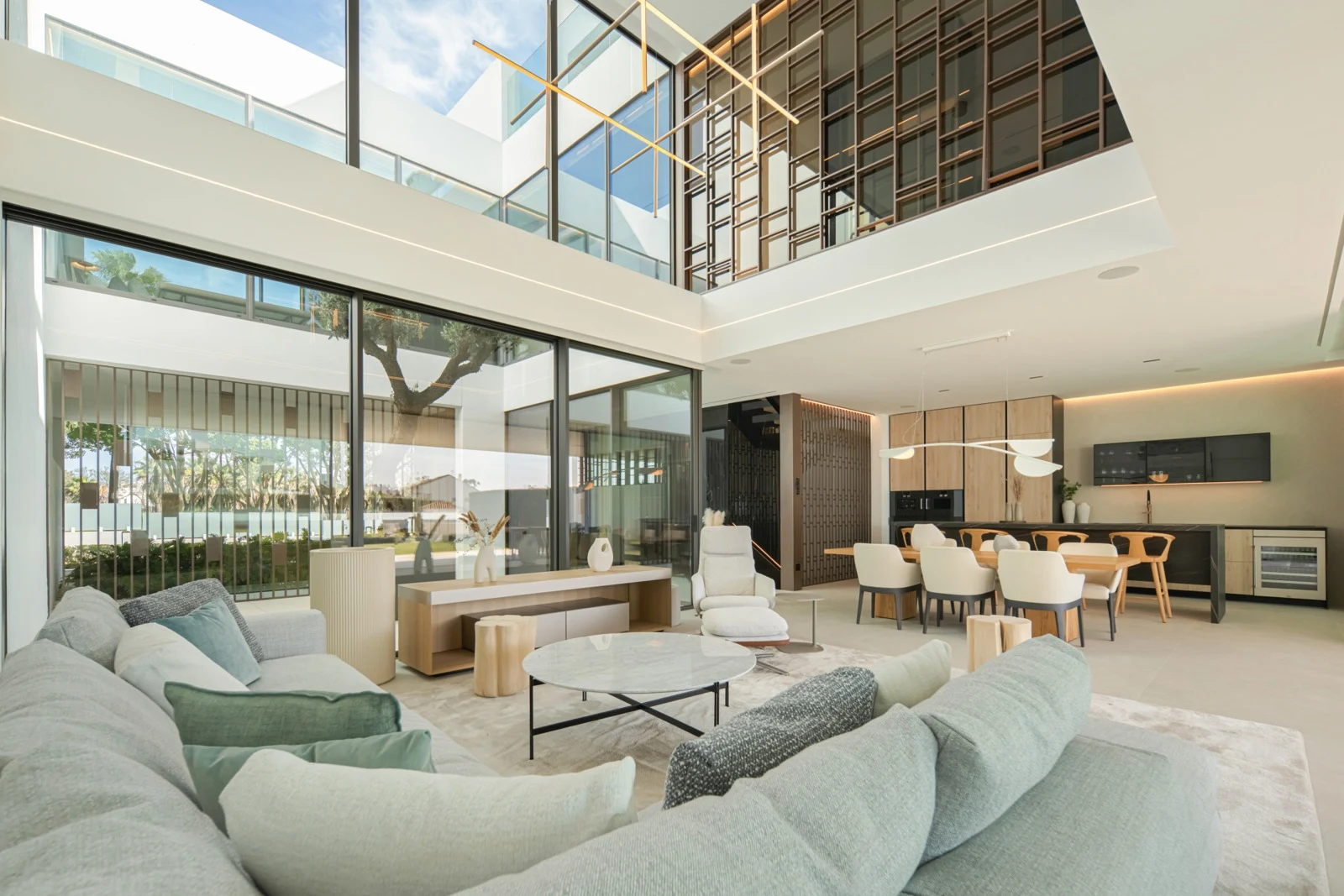 Double-height living room with broad sliding glass doors