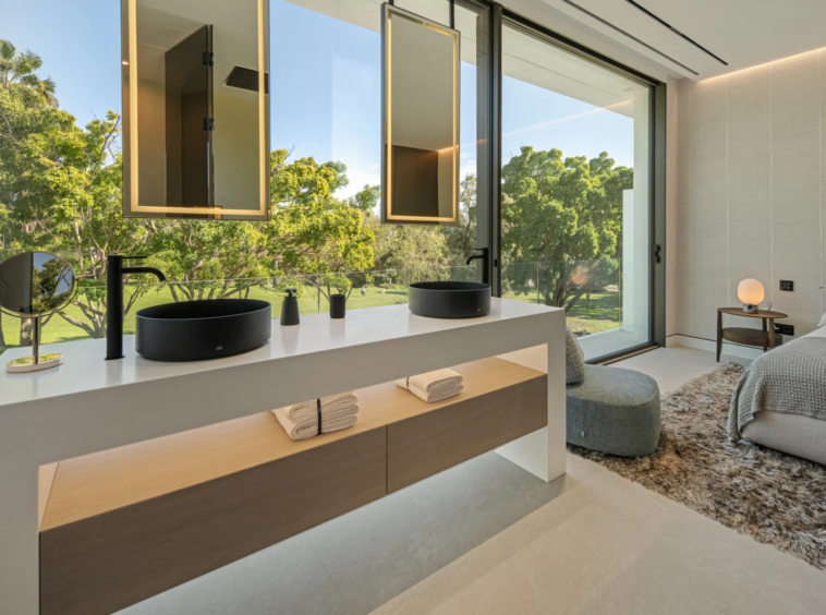 Bathroom vanity beside a large window