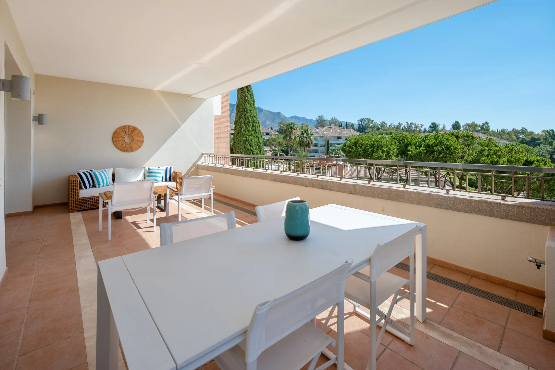 Outdoor dining space overlooking gardens and the sea