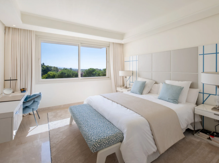 Bedroom with fitted wardrobes and natural light