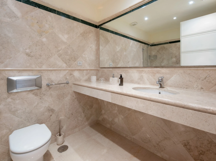 Bathroom with marble countertop and mirror