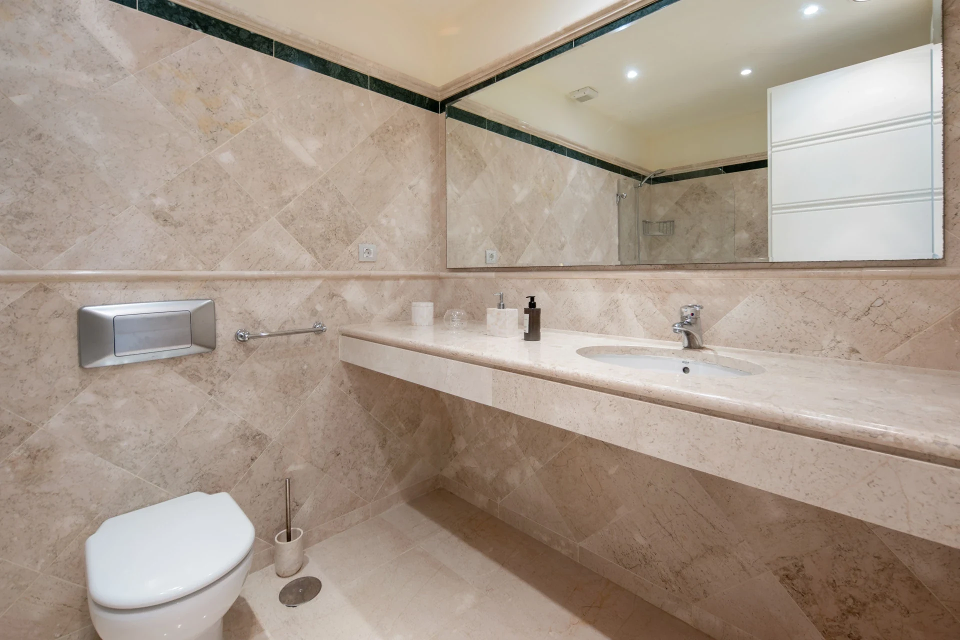 Bathroom with marble countertop and mirror