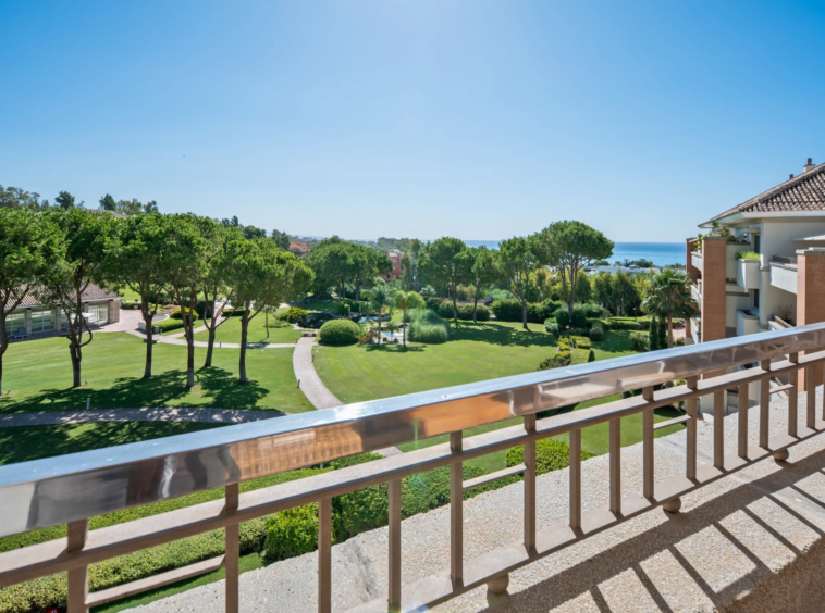 View across communal gardens towards the Mediterranean