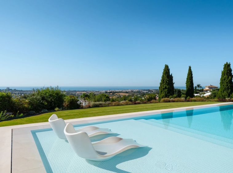 Private outdoor swimming pool with distant sea views