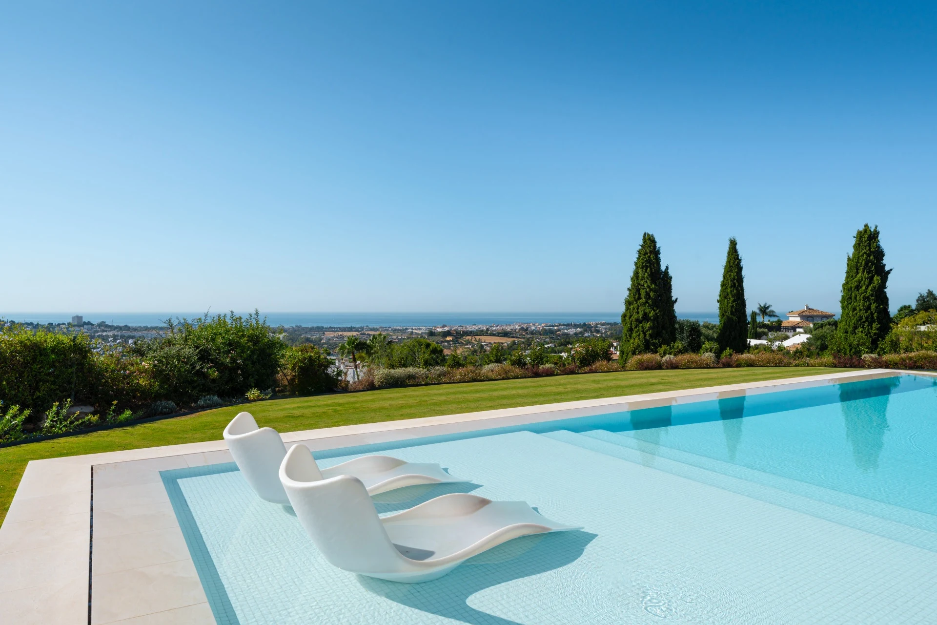 Private outdoor swimming pool with distant sea views