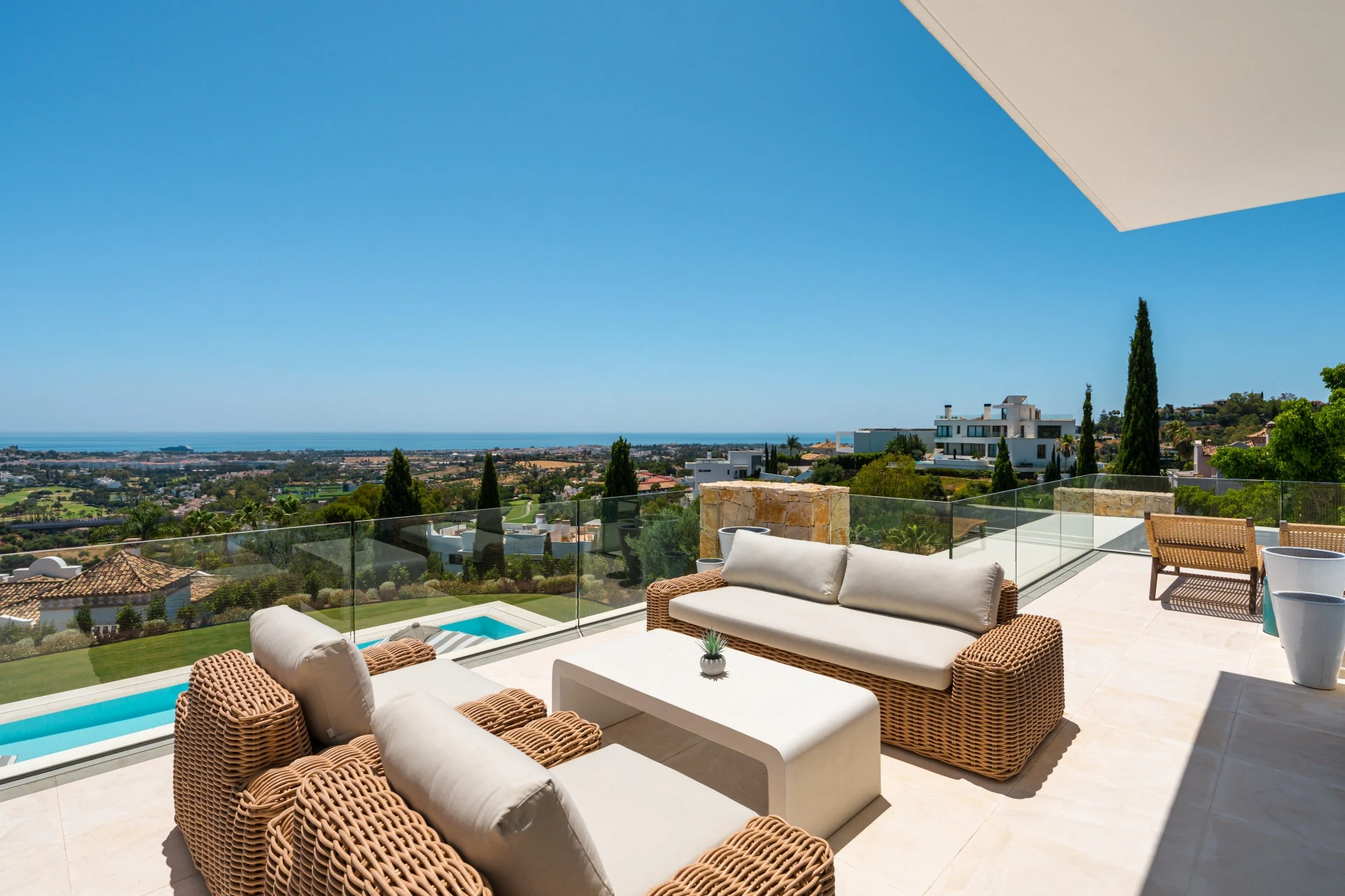 Upper terrace with seating and views towards the Mediterranean