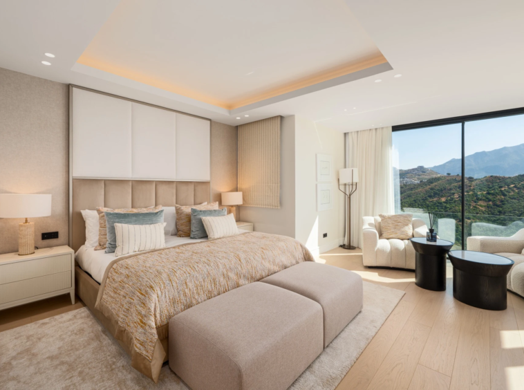 Bedroom with mountain views and seating area