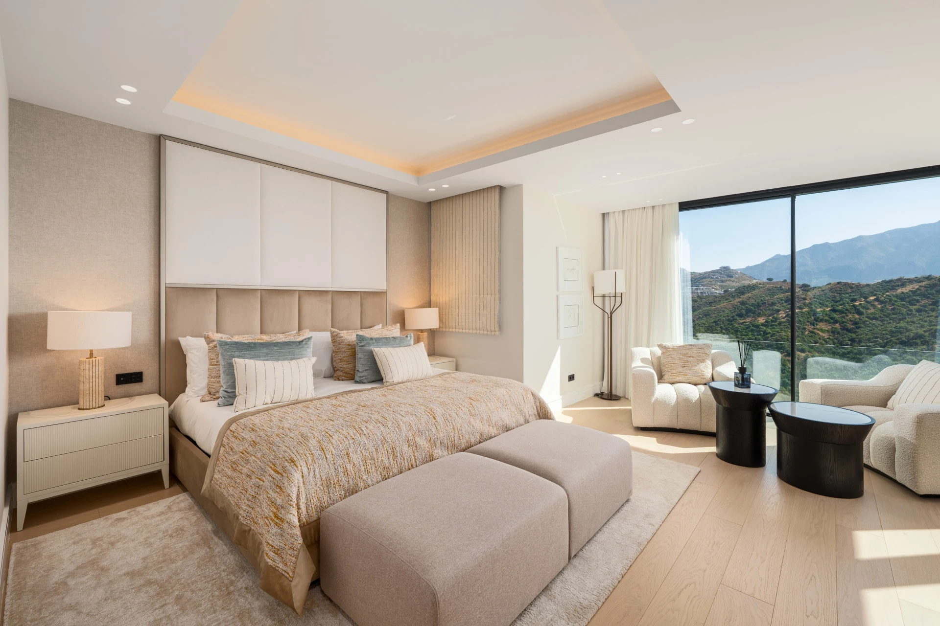 Bedroom with mountain views and seating area