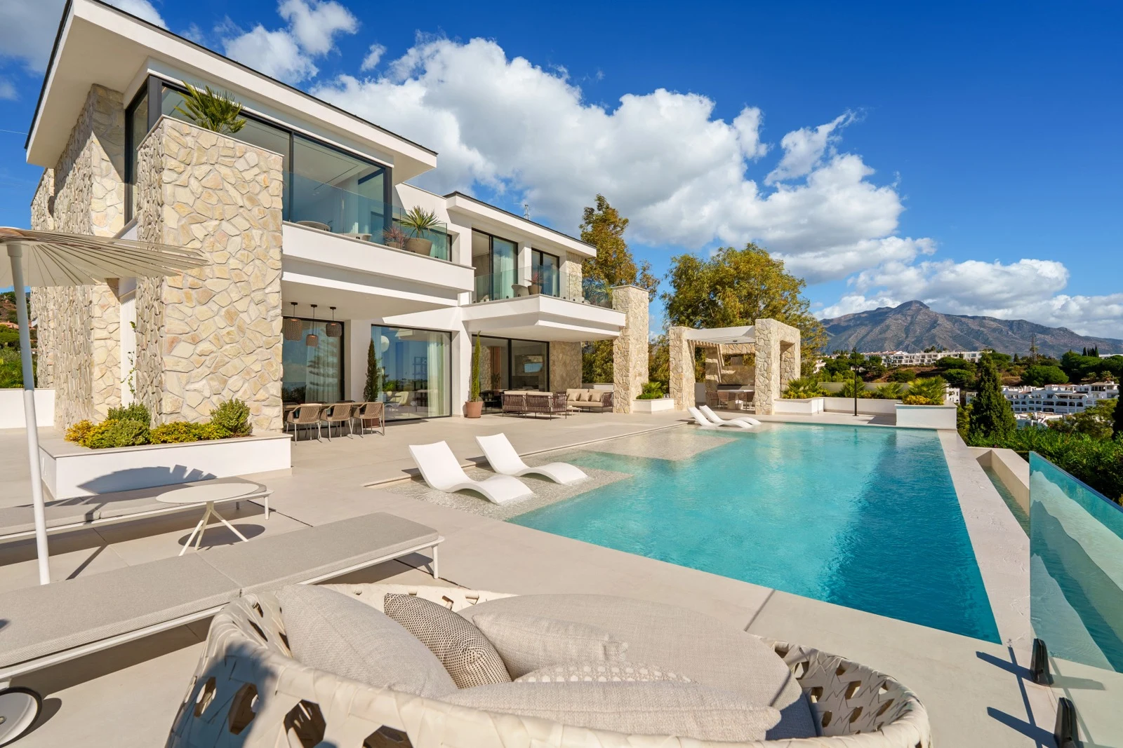 Poolside terrace beside the villa and landscaped grounds