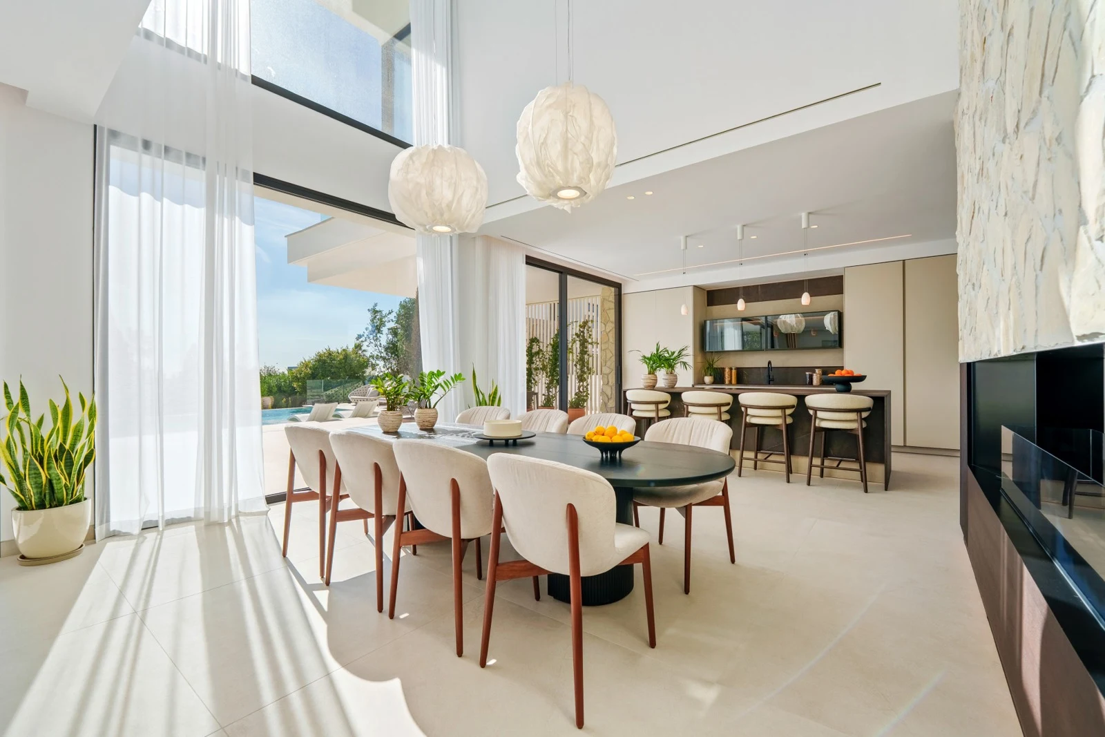 Open-plan dining area beside full-height windows