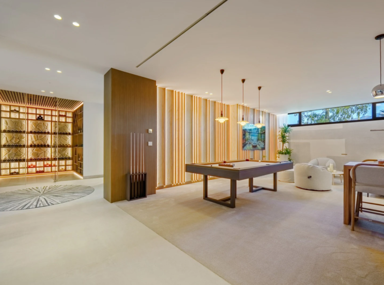 Lower-level entertainment room with games table and seating