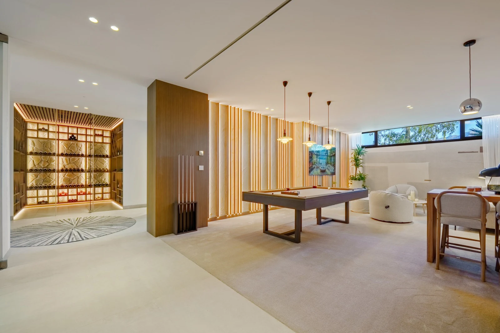 Lower-level entertainment room with games table and seating