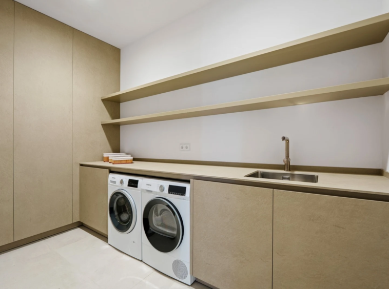 Laundry room with appliances and storage