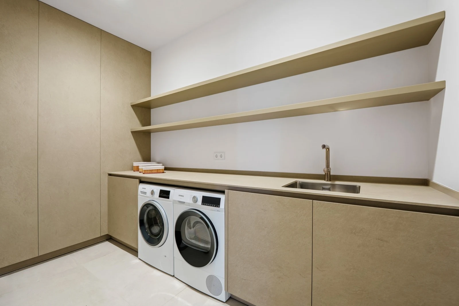 Laundry room with appliances and storage