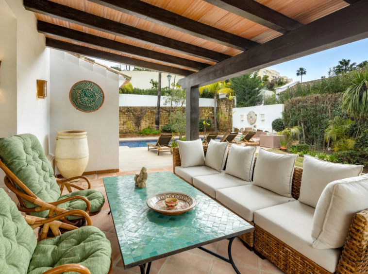 Covered outdoor lounge beside the garden
