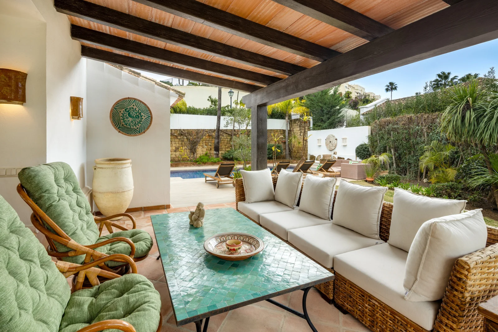 Covered outdoor lounge beside the garden