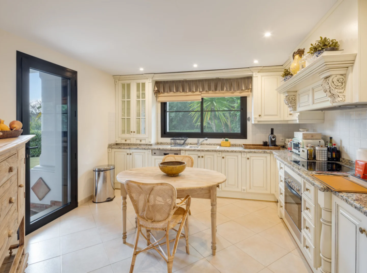 Kitchen with breakfast table and garden window