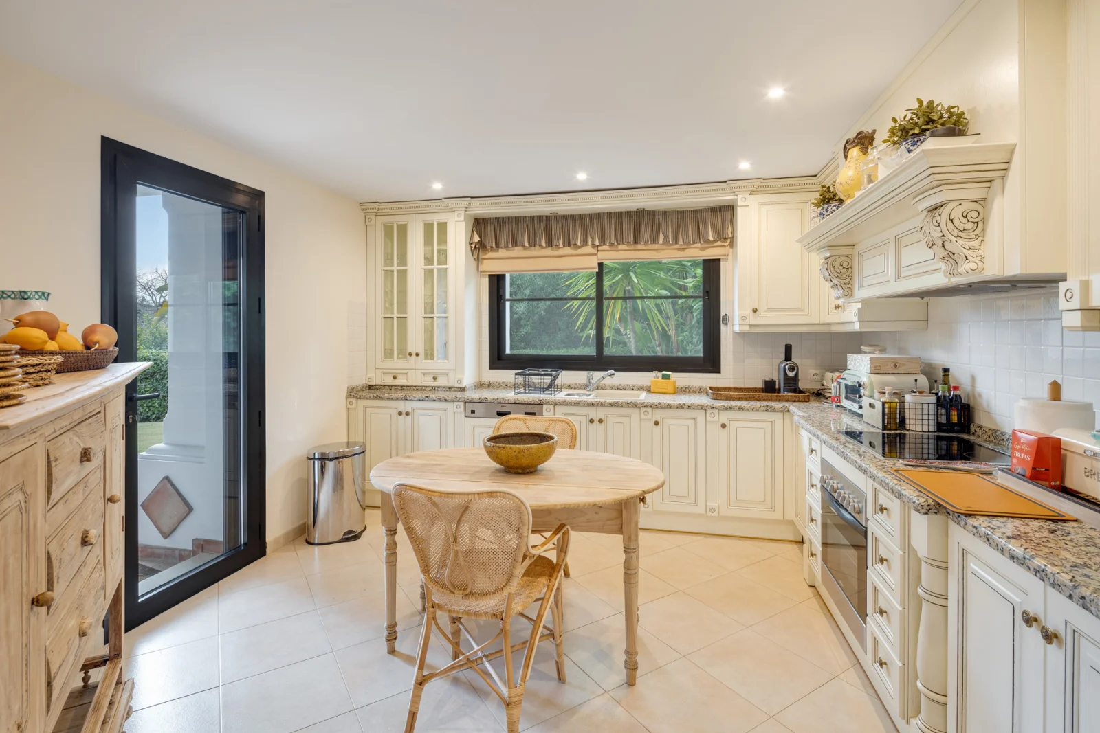 Kitchen with breakfast table and garden window
