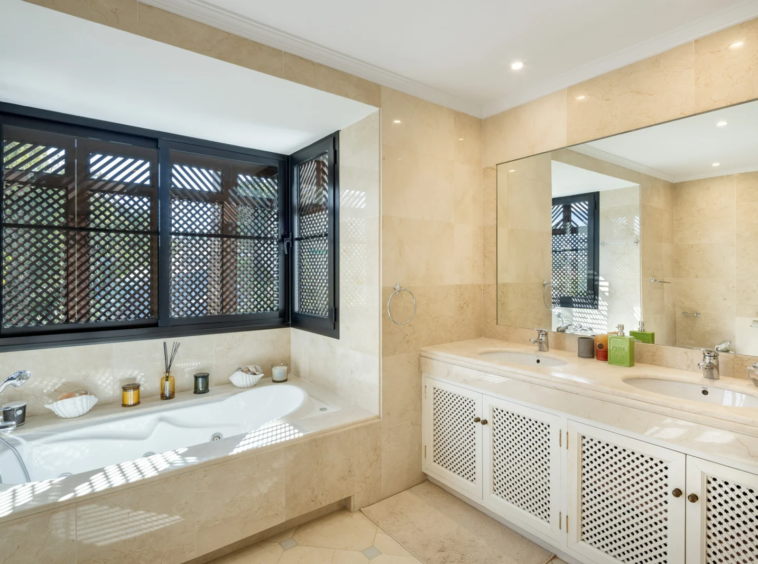 Bathroom with bathtub and double vanity