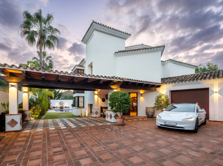 Villa entrance and covered parking at dusk