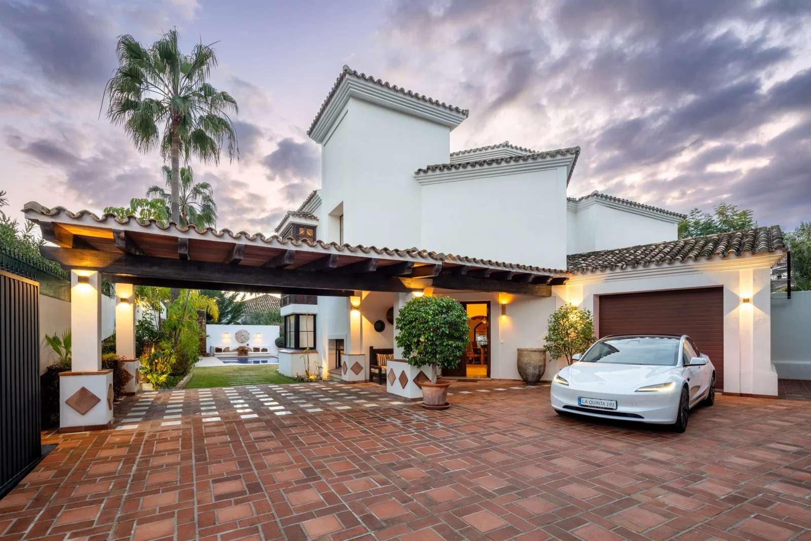 Villa entrance and covered parking at dusk