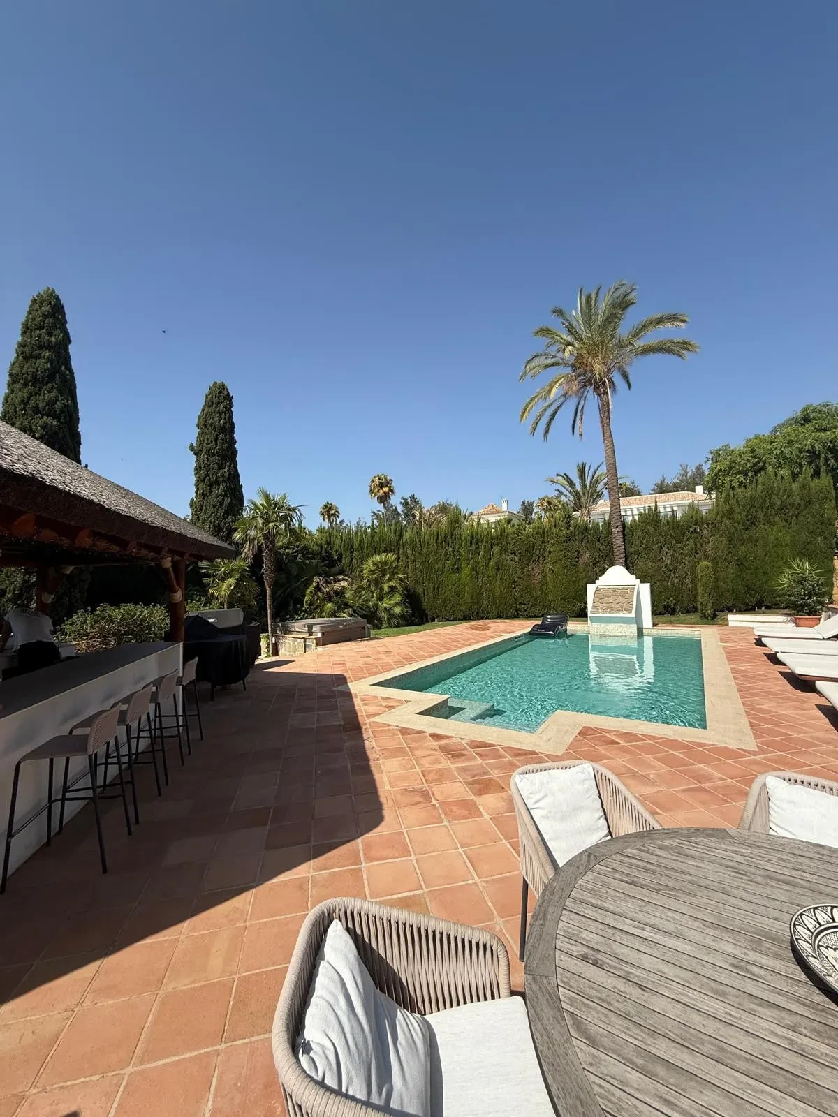Swimming pool beside a covered outdoor area
