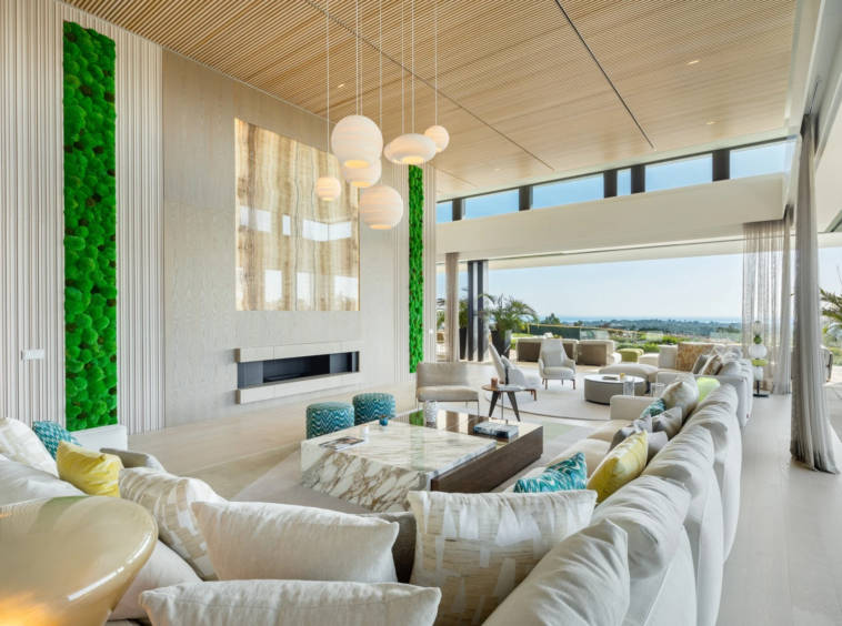 Double-height living room with large windows and garden views