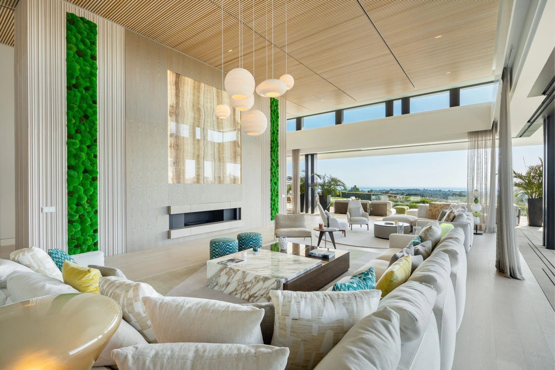 Double-height living room with large windows and garden views