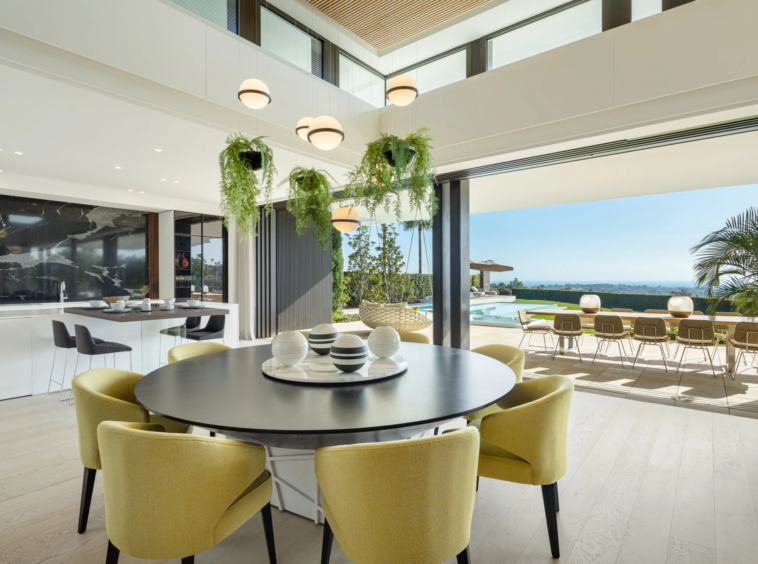 Dining area opening onto a terrace with sea views
